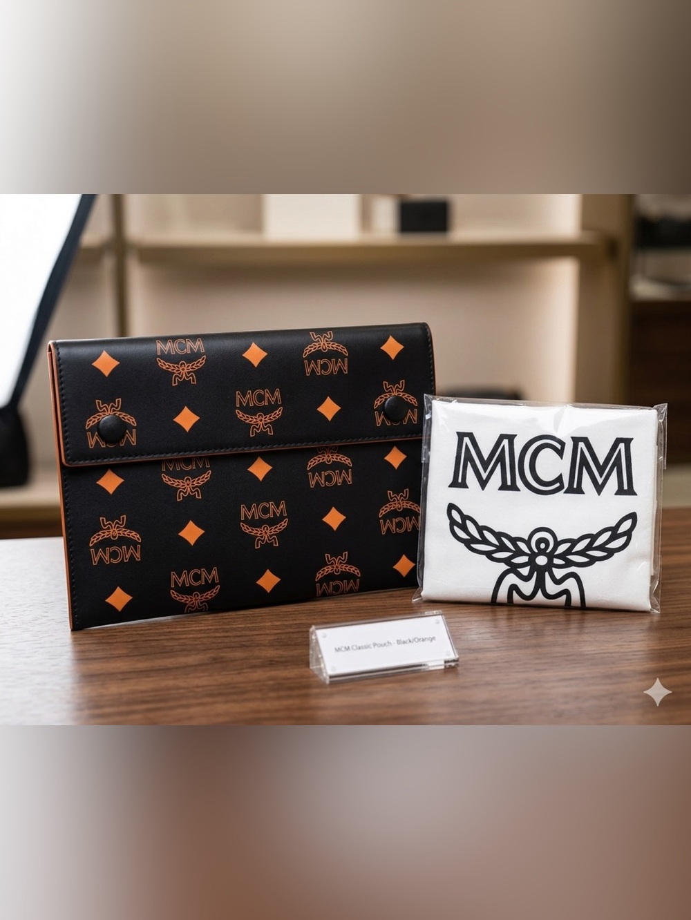 MCM Maxi Visetos Aren Clutch Pouch Black featuring an Orange Monogamous Pattern